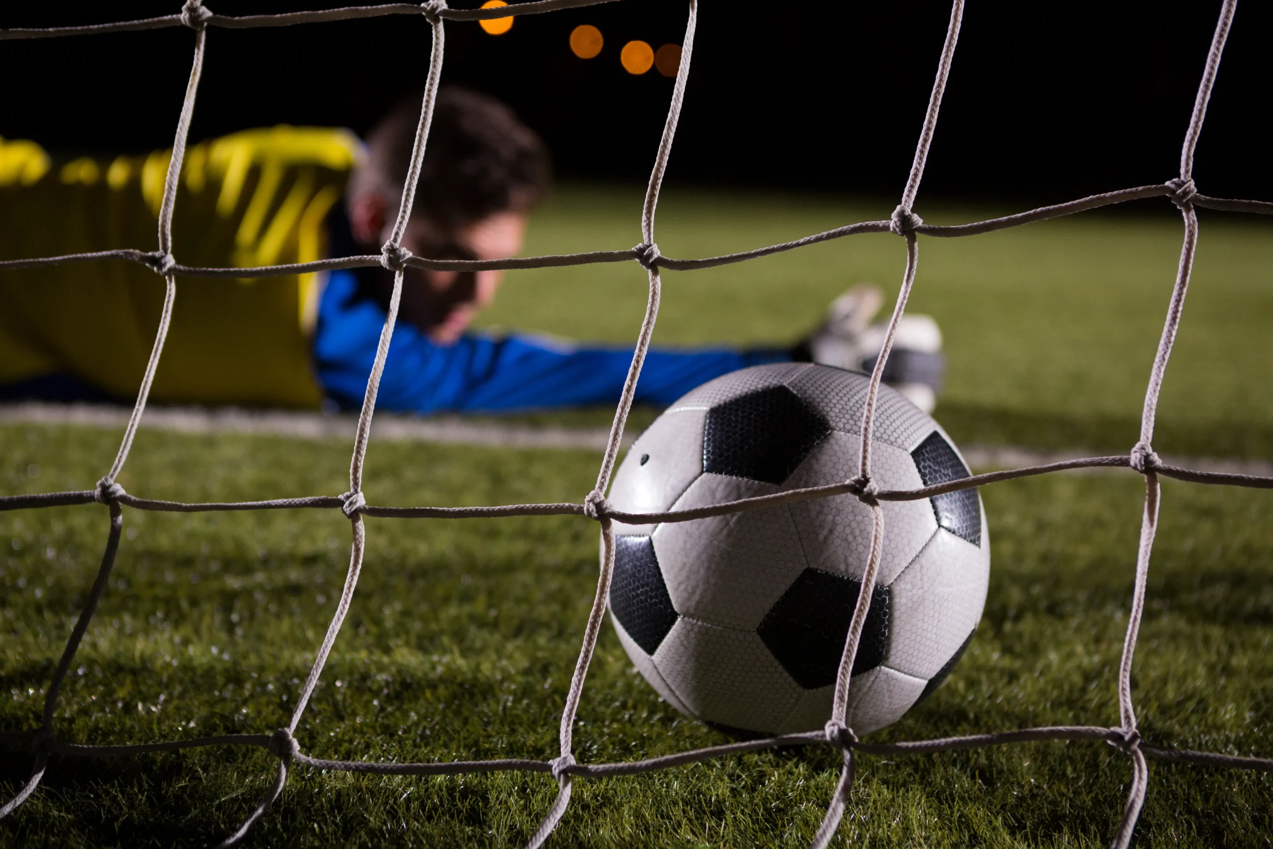 close-up-of-soccer-ball-in-goal-post-against-goalk-2021-08-28-17-56-29-utc